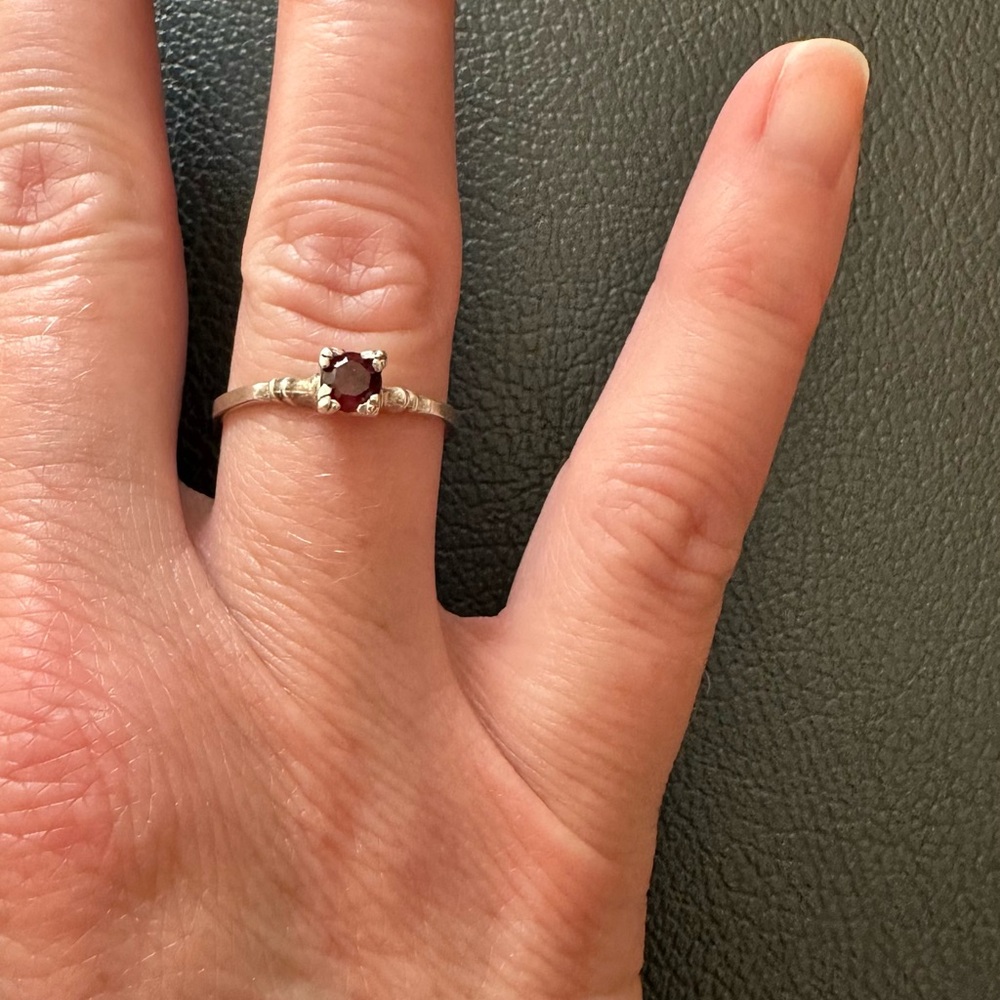 Dainty lightweight silver and red stone ring.